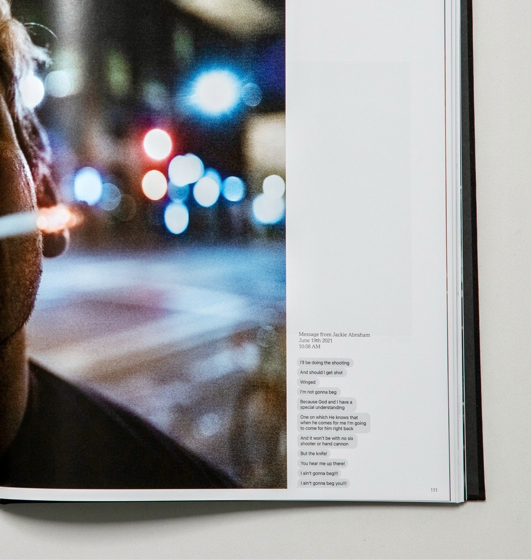 A page detail: a person in profile lit by blurred city lights, with a column of small text